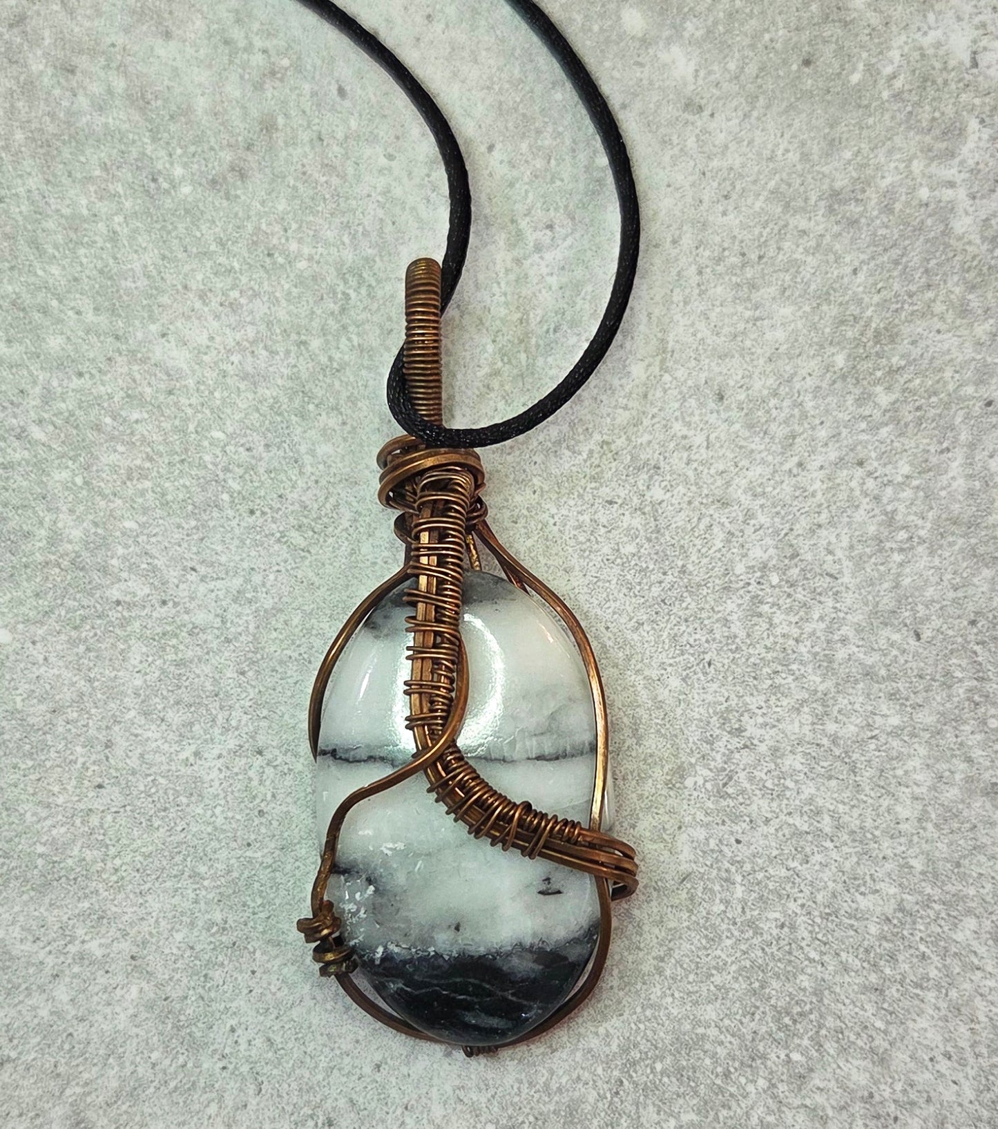 Black Zebra Jasper-wrapped in aged copper-comes on a black cord