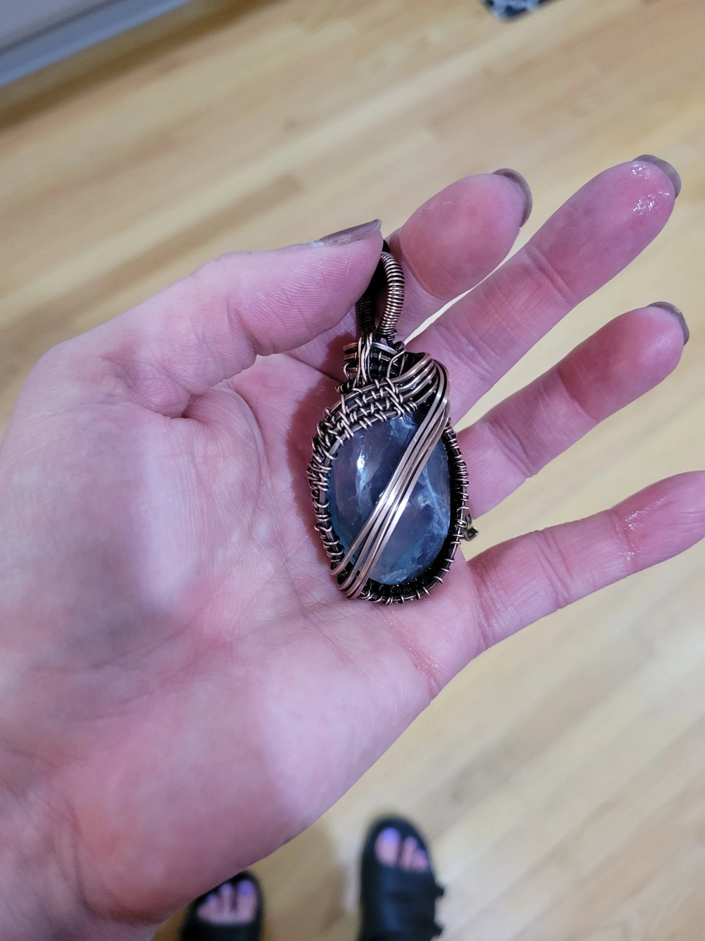 Fluorite pendant wrapped in aged copper