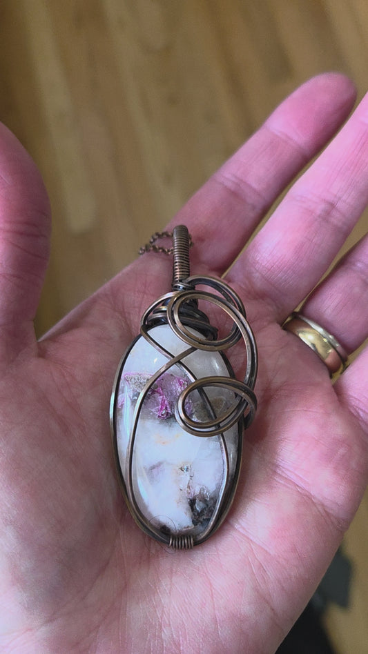 Thulite wrapped in aged copper