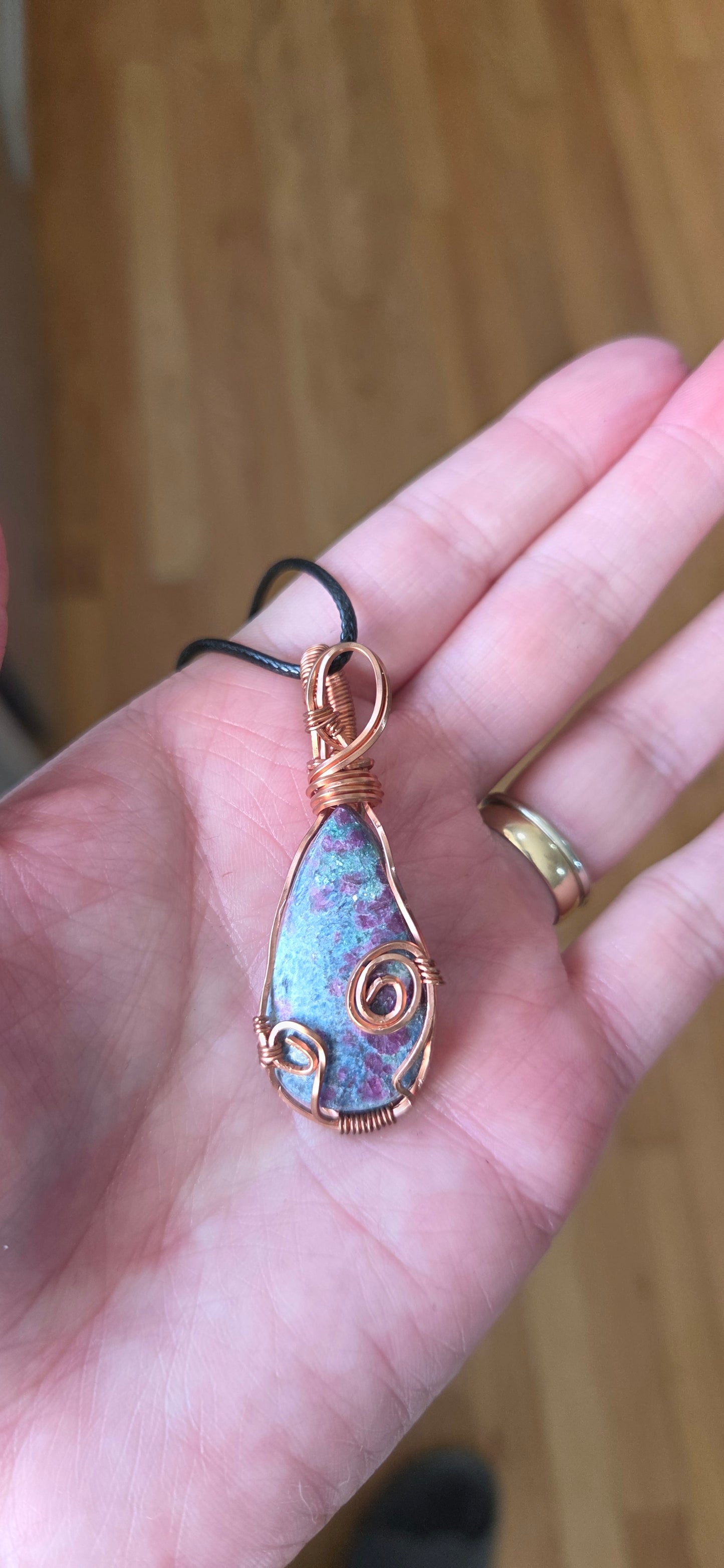 Ruby in Kyanite-wrapped in copper-comes on a black cord