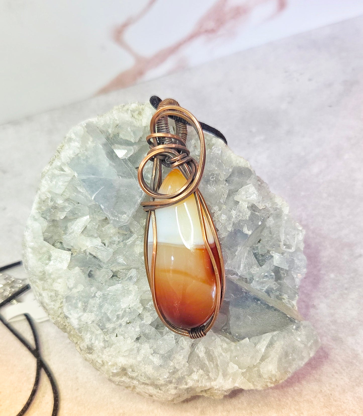 Carnelian pendant wrapped in copper.