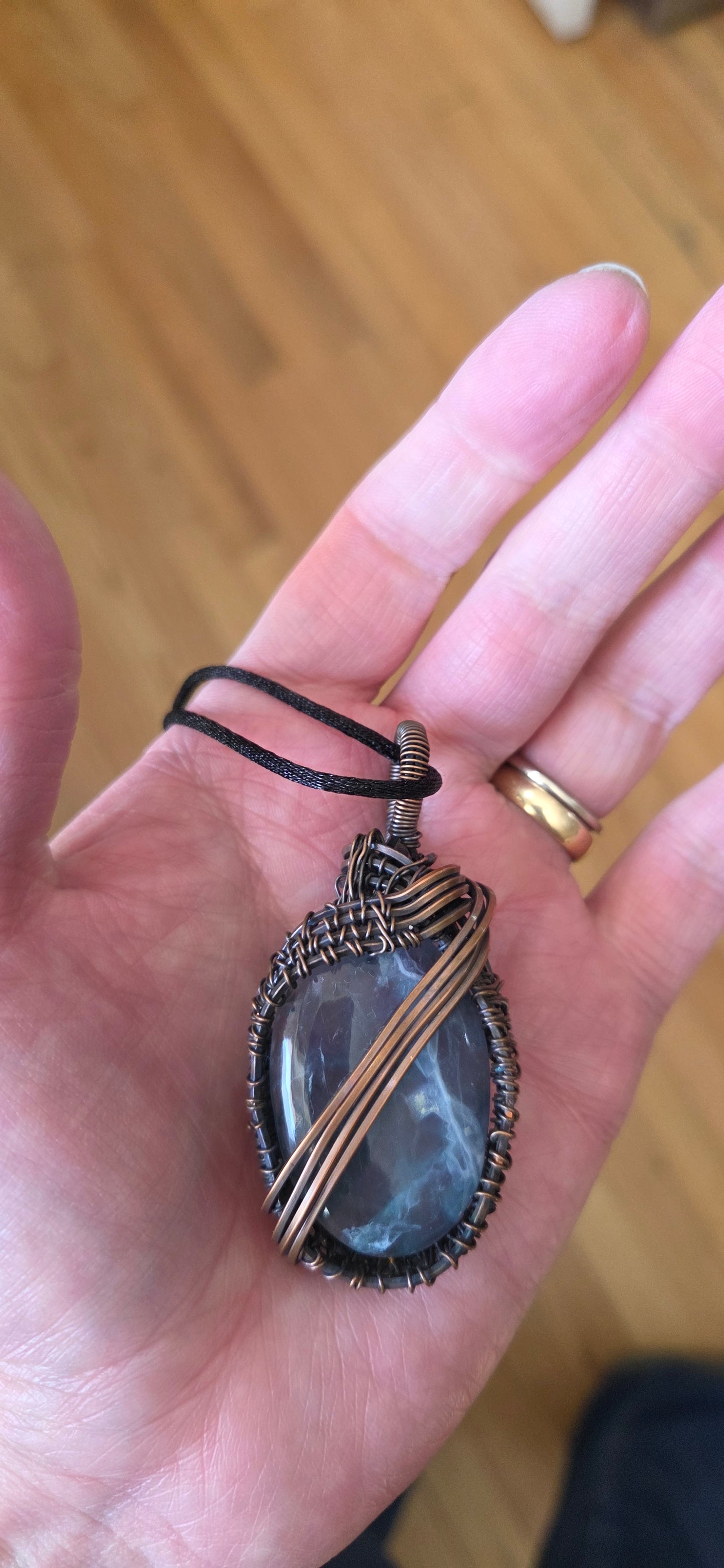 Fluorite pendant wrapped in aged copper