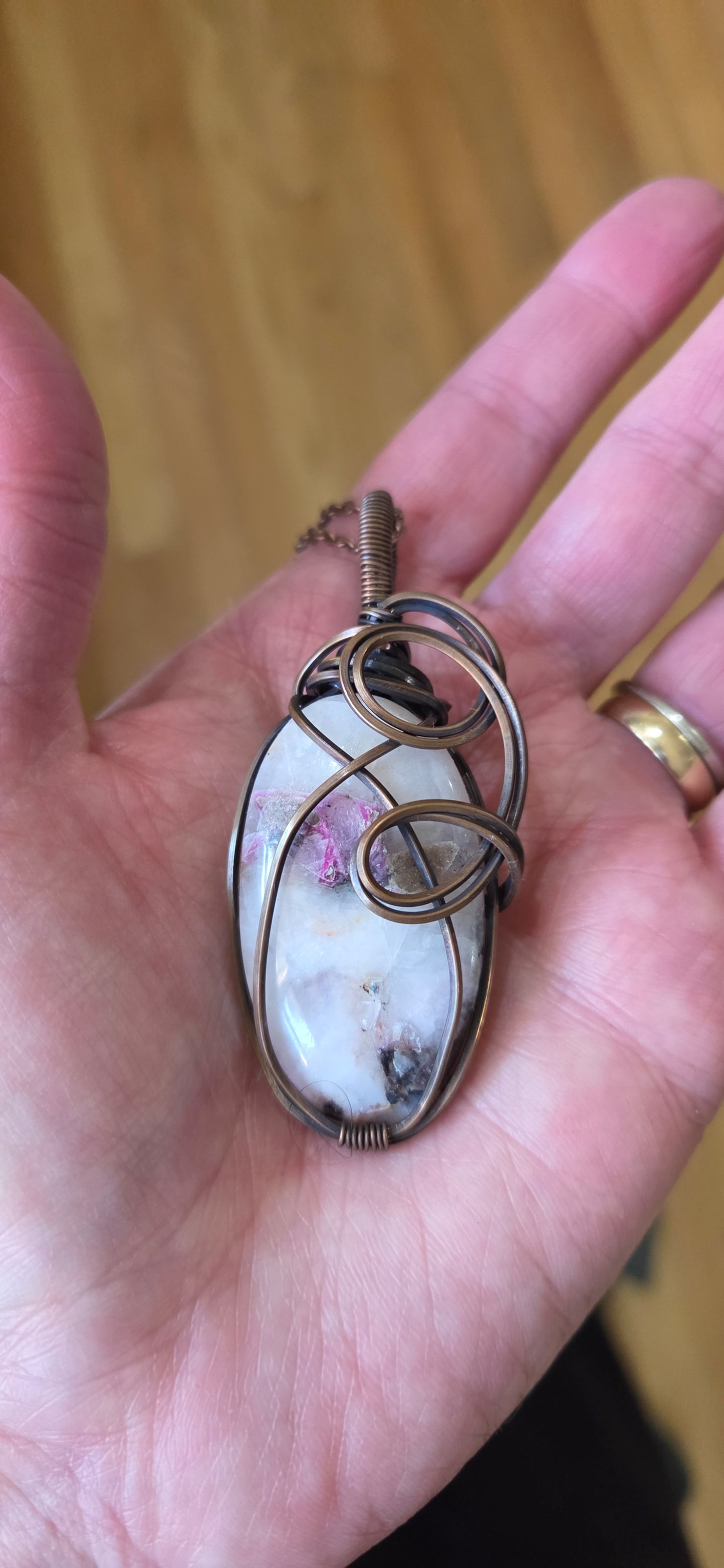 Thulite wrapped in aged copper