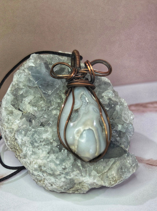 Druzy pendant wrapped in a copper bow