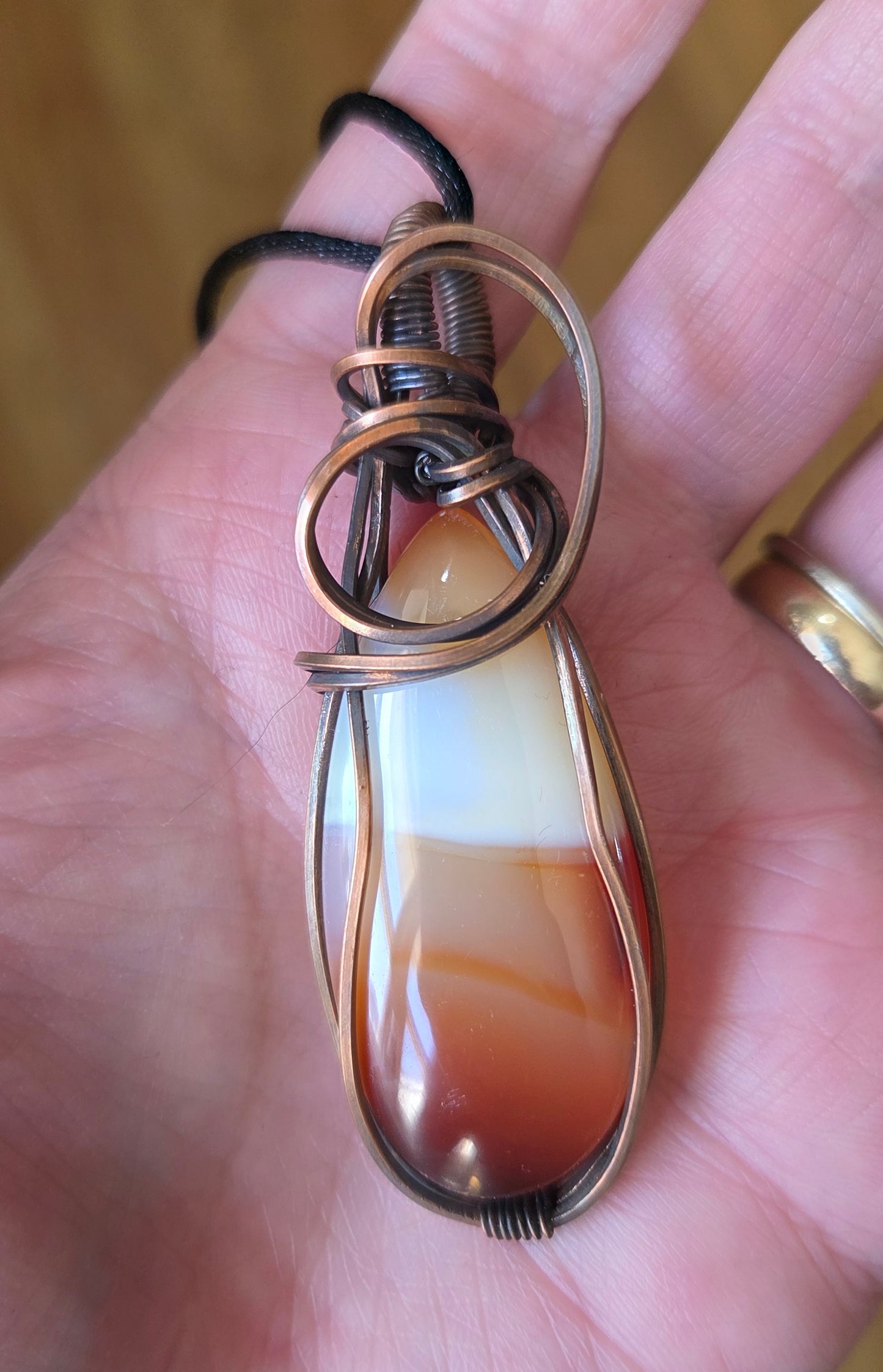 Carnelian pendant wrapped in copper.